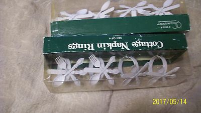 white napkin rings have tiny white silver wear on them a country cottage look se