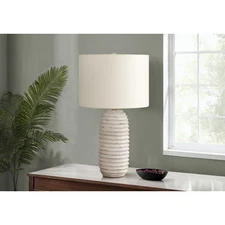 PA 28"H Table lamp with a distressed cream resin base in a ridged