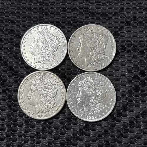 Four Morgan Silver Dollars 1884 CC , 1886 O , 1900 P , 1898 P in XF to AU Cond