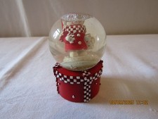 SNOWMAN SITTING ON A PRESENT SMALL SNOW GLOBE.