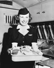 flight attendant an unspecified airliner smiles standing plane's g- Old Photo