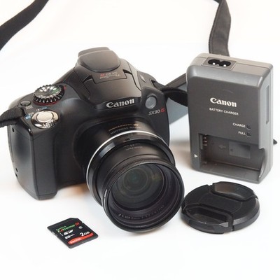 Canon SX30 IS digital camera with 2GB card, battery, and charger
