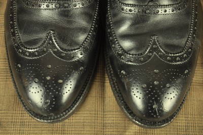 Alden 903 Wing Tip Bal is built on the Hampton last. The model has a black Calfskin leather upper with a single leather outsole.