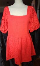 Very Orange Top featuring a shirred bodice and broderie anglaise puff sleeves