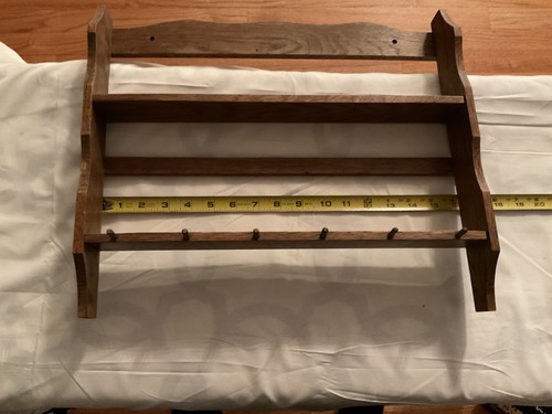 Vtg wooden wall - mounted rack used as a spice rack for plates and cups.