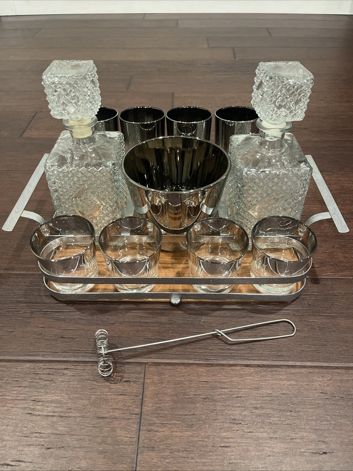 Dorothy Thorpe's iconic silver-banded decanter set with tray is one of the most recognizable and coveted names in 1950s American MCM barware.