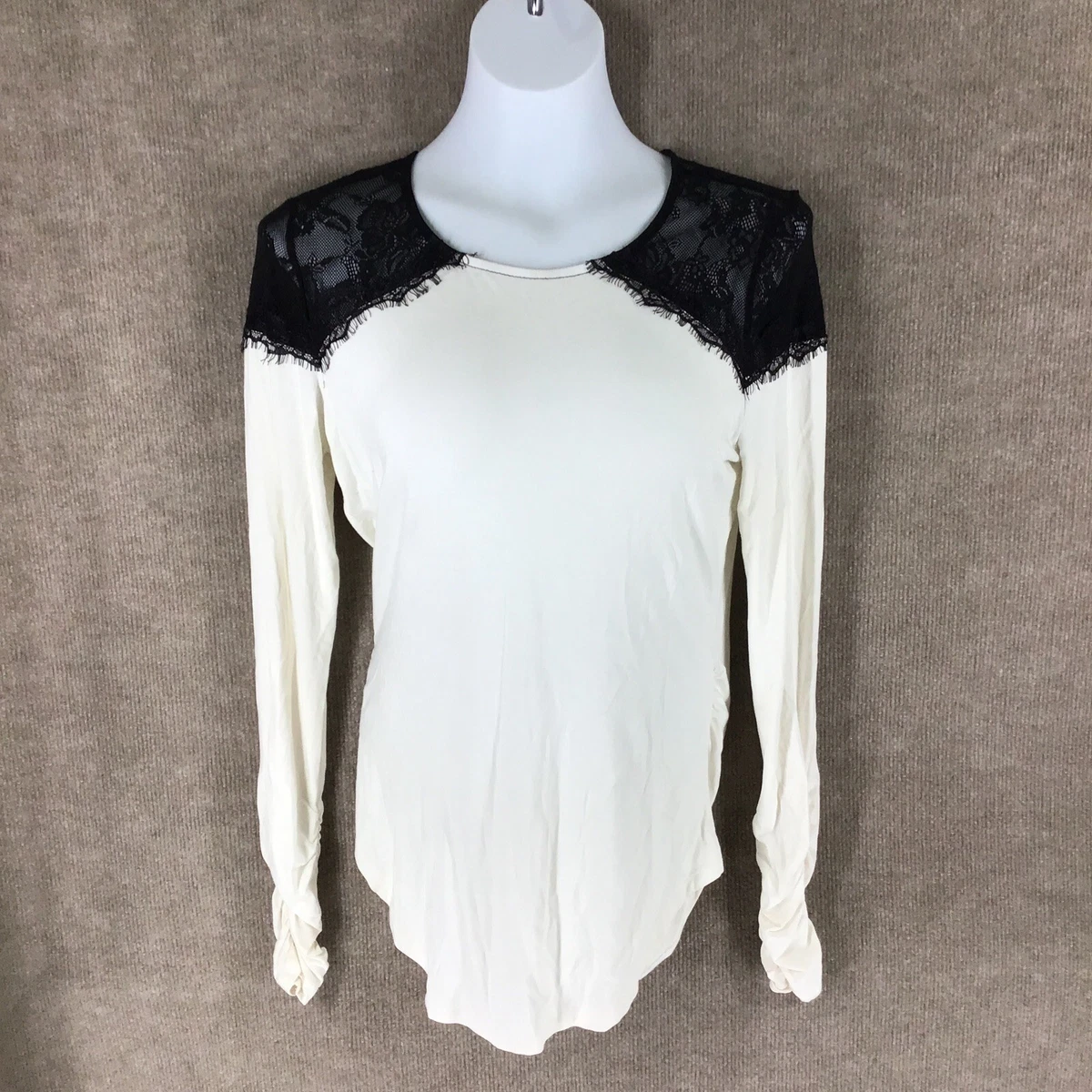 cream blouse with black trim