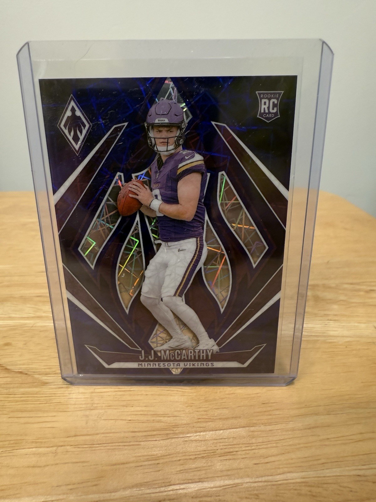 2024 Panini Phoenix - Rookies J.J. McCarthy #185 Blue Laser /125 (RC)