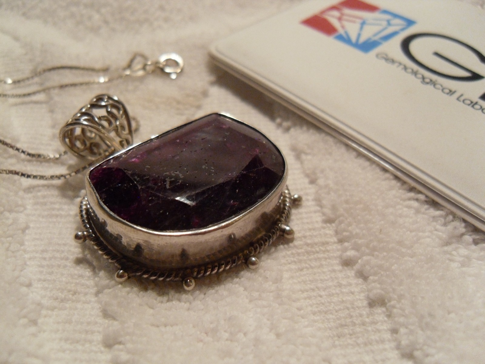 Stunning 50 carat pigeon-blood-red ruby half moon pendant