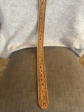hand-tooled leather belt with a floral pattern and a metal buckle. Size 28