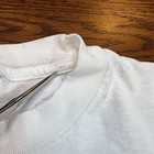 White ribbed Reebok Runners T shirt with black collar stitching, single stitch hem, and visible “Made in USA” text inside collar.
