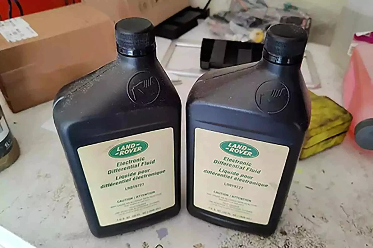 Two quarts of Land Rover electronic differential fluid, displayed on a workbench.