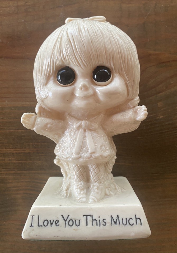 A genuine 1970 W&R Berrie Co. big-eyed 'I Love You This Much' desk paperweight — pure retro sentimental kitsch with real vintage provenance and instant nostalgia punch.