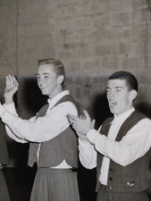 Six Boys in skirts vintage, maybe from the 1960's, clapping, maybe doing a dance