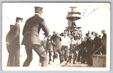 Sailors in Three-Legged Race on Navy Ship Deck, with Officers Officiating RPPC