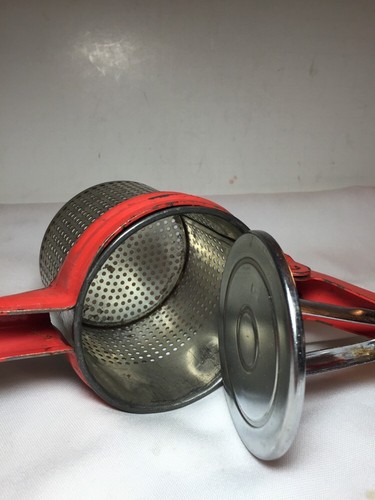vintage masher metal juicer orange painted handle potato rice