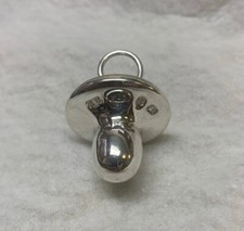 Sterling silver dummy /pacifier designed to hold babies first tooth lock of hair