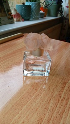 A Empty Bottle Of  Mariella Burani Eau Rosee 50 Ml. A Rose On Top.