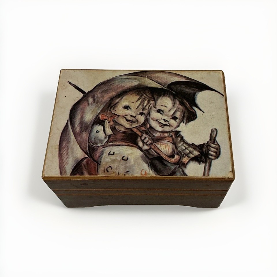 A genuine Hummel-themed wooden jewelry box with a 30-note SANKYO movement playing 'Stormy Weather' — this is the kind of piece serious collectors actually hunt for.
