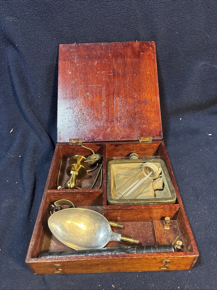 A mysterious early 1900s wooden-cased scientific instrument set — the kind of thing a Victorian mad scientist would keep on their desk.