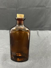 vintage-style amber glass vial with a cork stopper