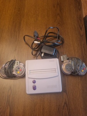 SNES Junior console with two controllers. Super Nintendo Jr. with cables