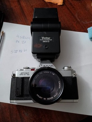 CANON AV-1 SILVER 35mm CAMERA, 50 mm FD 1:18 LENSE, VIVITAR 2800 D new battery.