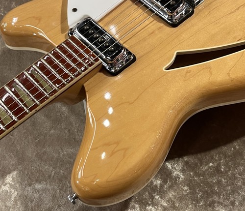 Light maple Rickenbacker 360 MG with gold hardware, three pickups, and cutaway body on metallic finish.
