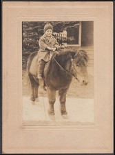 Robert Sherman, age 3, in knit cap riding on a pony photograph ca 1910 Robert Sherman, age 3, in knit cap riding on a pony photograph ca 1910