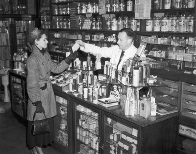 Woman hands over a prescription in a chemist's shop in Fleet Stree- Old Photo