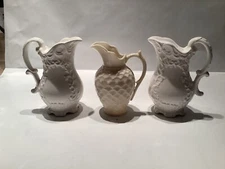 Matching Pitchers salt and pepper shakers with similar cream pitcher