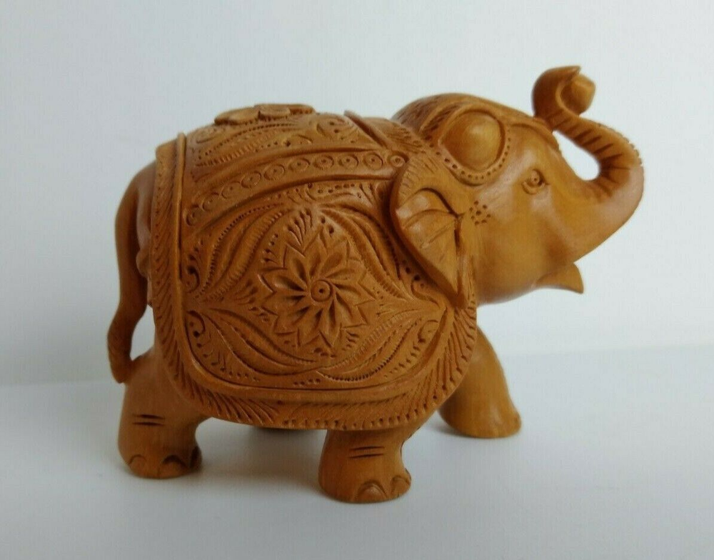 Small Carved Wooden Elephant Wearing a Decorative Coat and Head Cover