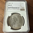 An 1887 MS64+ (NGC) Morgan Silver Dollar