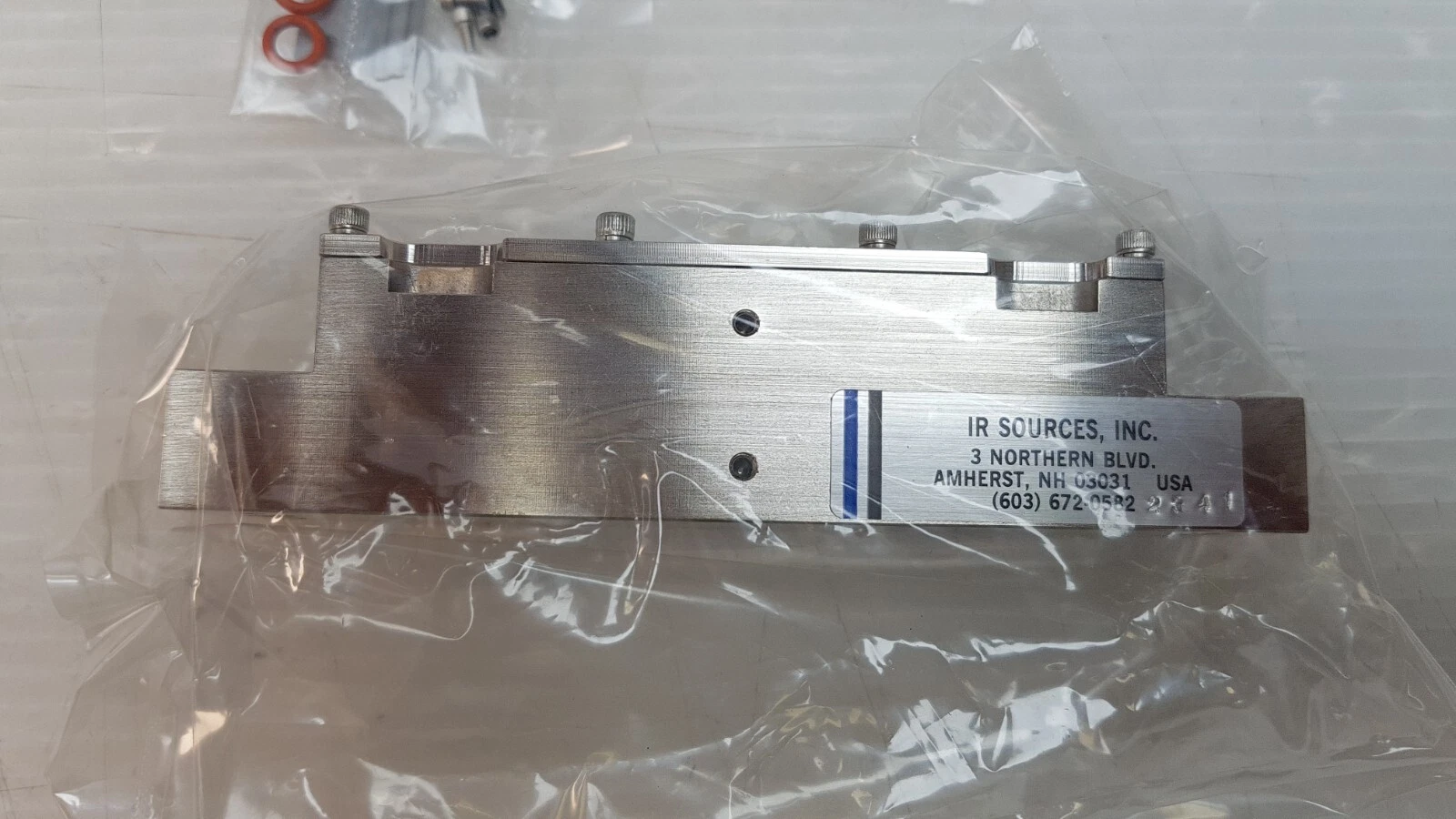 Side of the laser pump cavity with IR Sources, Inc. Amherst NH plate