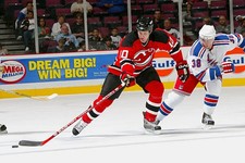Center Erik Rasmussen New Jersey Devils evades center Jarkko- Ice Hockey Photo