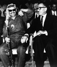 Yasser Arafat leader of PLO holding a Russian made machine gun laug- Old Photo