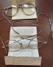 Two pairs of vintage eyeglasses, likely from the early 20th Century