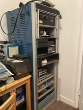 Full-height 19-inch rackmount cabinet, wired, with drawers and some panels.