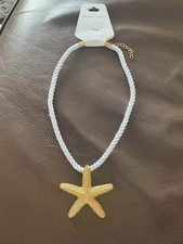 Gold Starfish Necklace On White Rope.