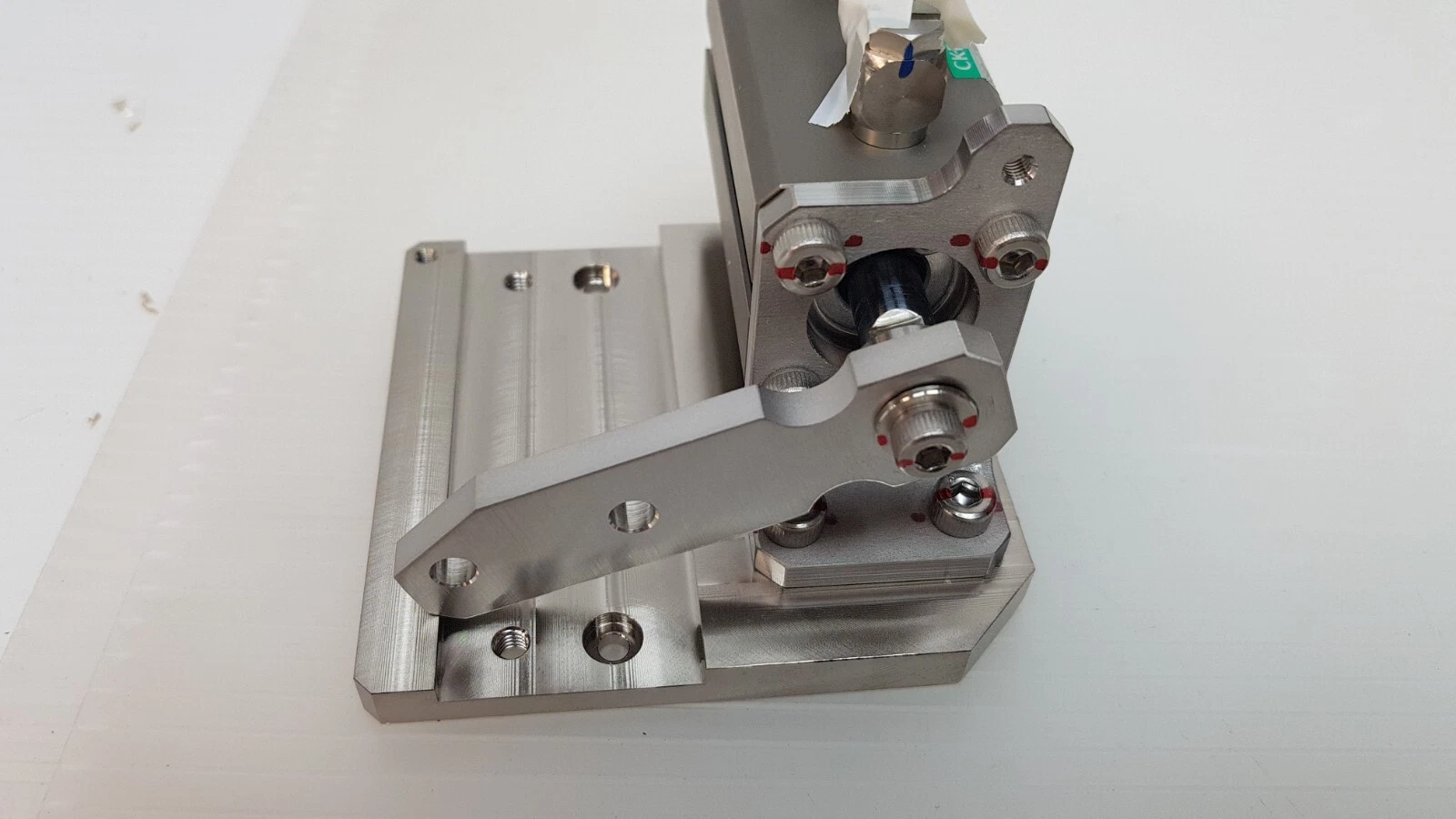 Air cylinder assembly from the lever side, showing bracket, link and fittings