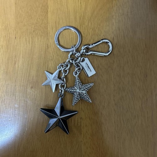 COACH Portachiavi Motivo Stella Borsa Charm Metallo Argento Nero Senza Scatol... - Foto 1 di 2