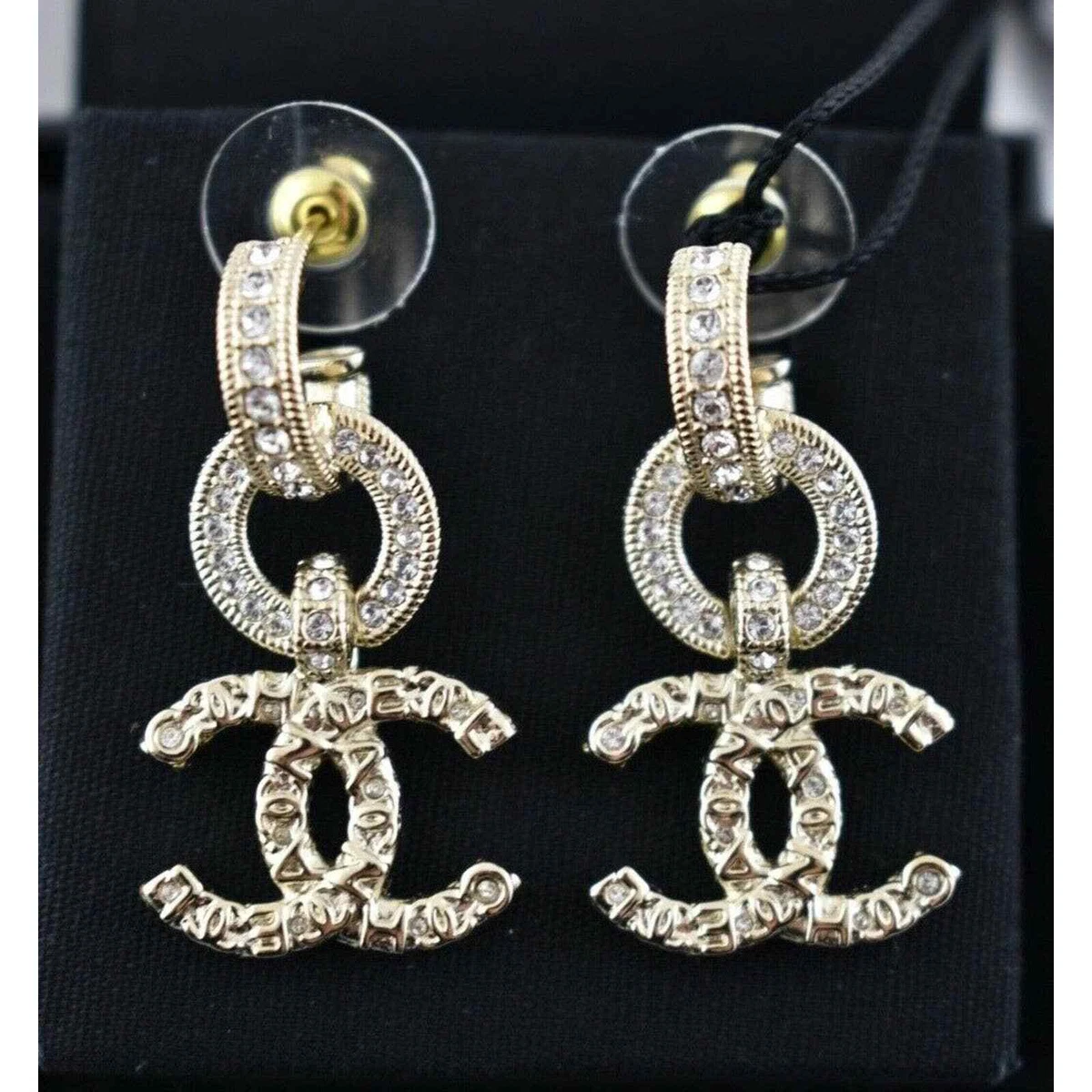 Chanel gold metal and crystals logo dangle earrings new