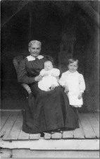 Woman Holding Baby With Child RPPC Postcard Rocking Chair Porch Dress