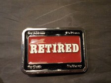 "Retired" red vintage belt buckle
