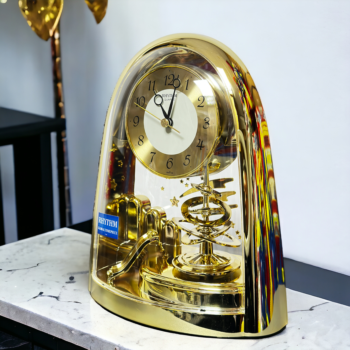 Rhythm Mantel Clock Gold with Rotating Pendulum and Shooting Stars