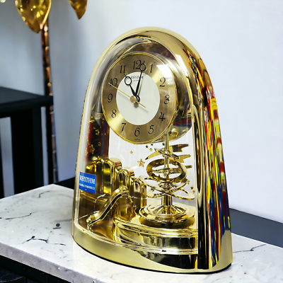 Rhythm Mantel Clock Gold with Rotating Pendulum and Shooting Stars  