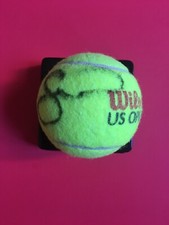 Autograph tennis ball signed by Serena and Venus Williams.