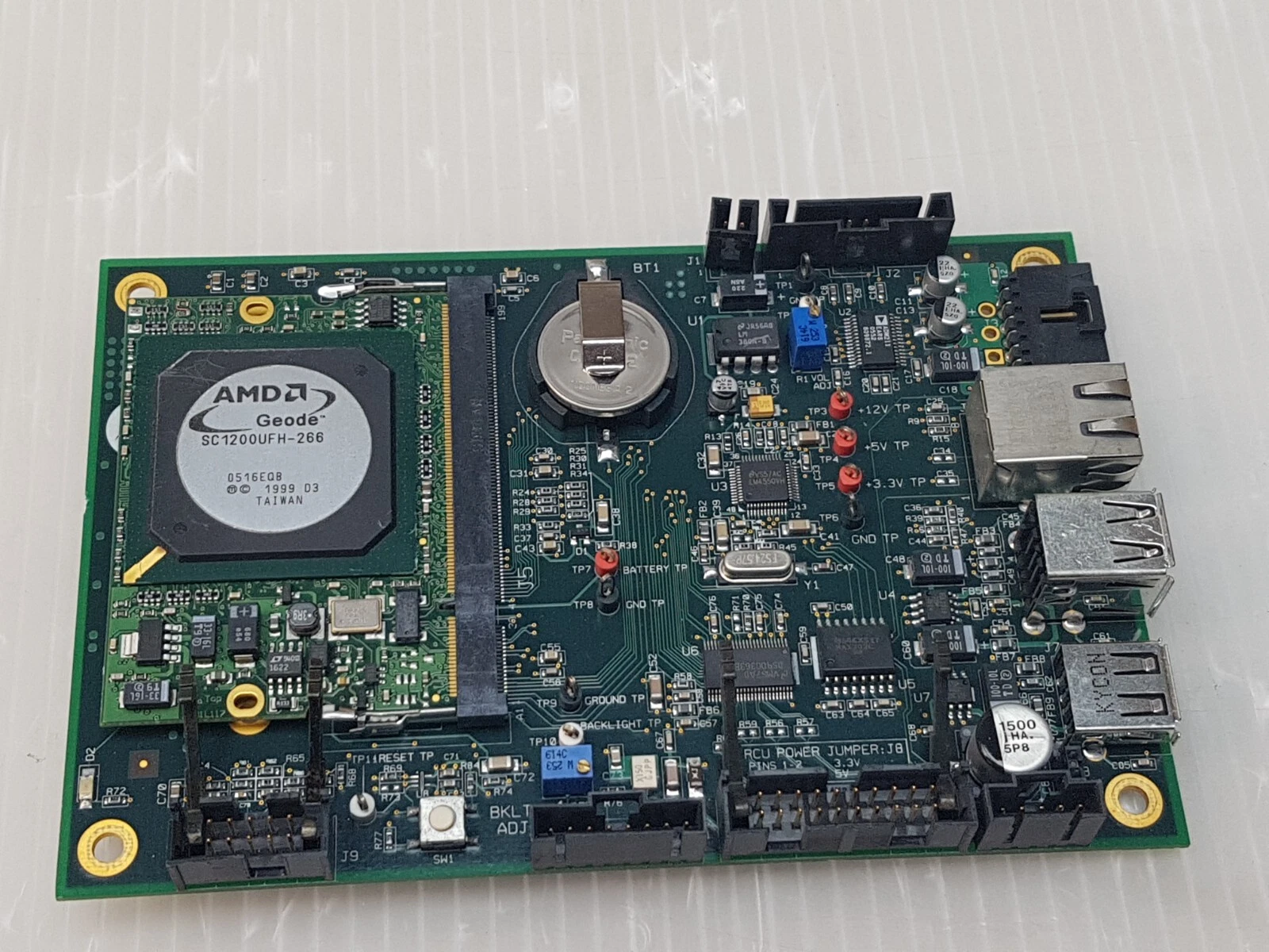 Kontron 800-689 board from an angle showing Geode module, battery holder and USB ports