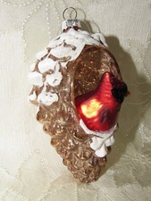 Blown glass ornament. Pinecone with cardinal bird insight.