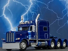 1/64 DCP SOVEREIGN BLUE PETERBILT 389 TRI AXLE W/ 70" MID ROOF SLEEPER